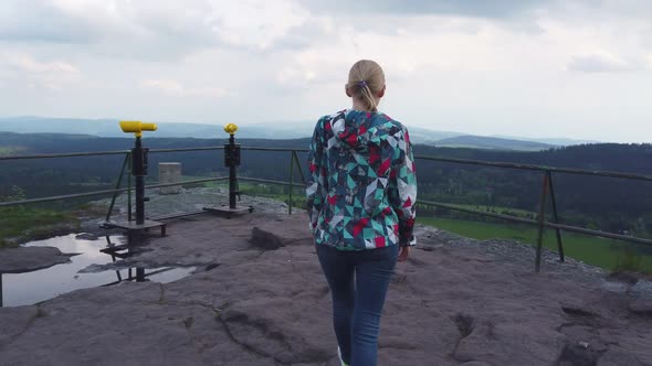 Woman Walks Along the View Point on Top of a Mountain