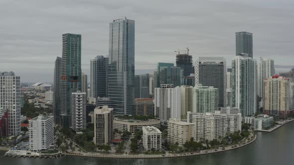 Aerial push heading towards buildings in downtown Miami