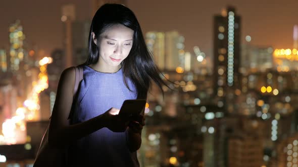 Woman use of cellphone at night