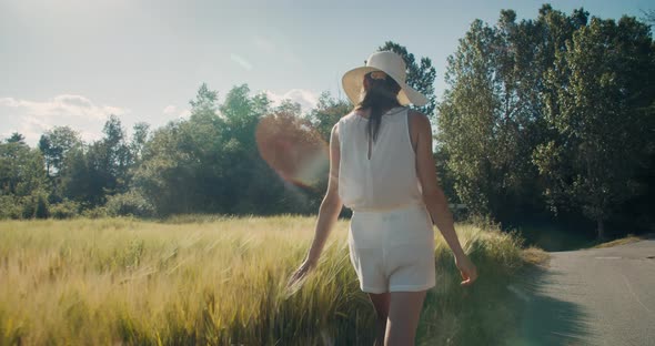 Attractive Young Adult Woman Enjoy Summertime Journey on Rural Environment