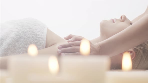 Young, healthy and beautiful woman gets massage therapy in the spa salon.