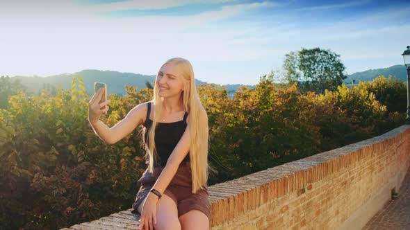 Woman Making Selfie on Smartphone in Front of Beautiful Nature Landscape
