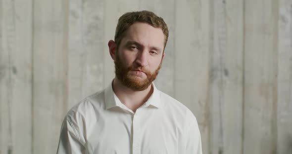 Young Attractive Man in a White Shirt Wears a Medical Mask