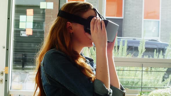 Female executive using virtual reality headset