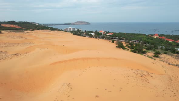 aerial of golden wavy ripples in the sand dune desert of Mui Ne Vietnam
