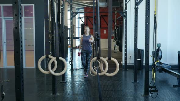 Young Sports Woman Passing at Fitness-Gym. Fit Girl Entering a Fitness Club  alt