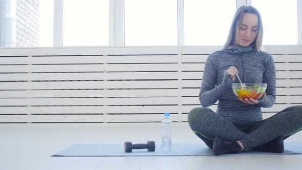 Healthy Eating Concept. Young Fit Woman Eating Healthy Salad After Workout