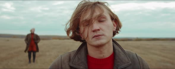 Portrait of Young Man on Autumn Field