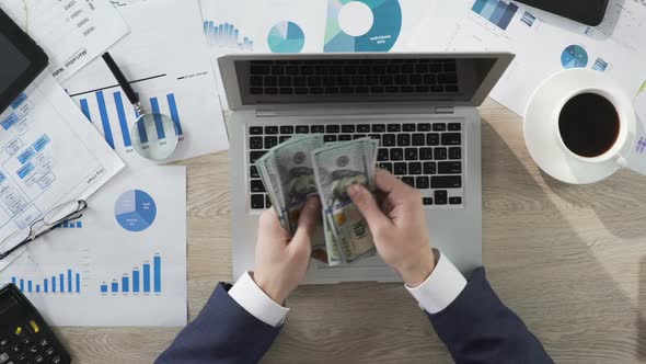 Business Person Counting Money at the Table, Large Income, Success. Top View