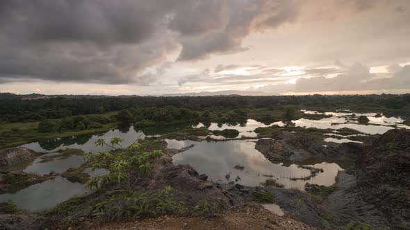 Timelapse sunset with moving cloud at dilapidated quarry 