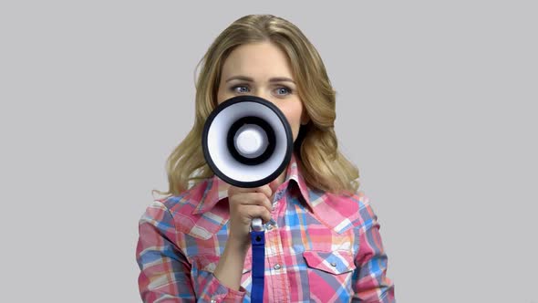 Happy Young Woman Giving Speech with Megaphone