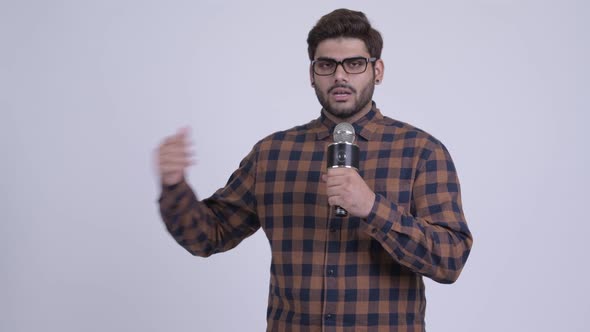 Young Bearded Indian Hipster Man As Host Making Mistake