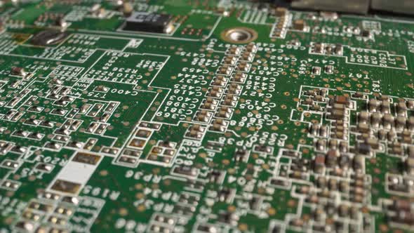 Extreme close-up of green Printed Circuit Board Electronics shot with dolly