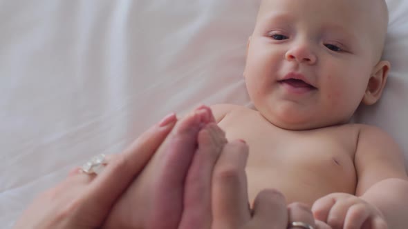 A Woman Playing with Baby Daughter's Feet