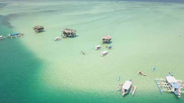 Drone Flight Over Scenic Tropical Beach Resort with Bungalows and Boats