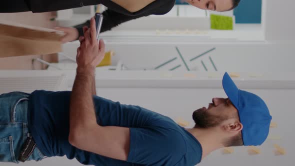 Vertical Video Delivery Man Bringing Takeaway Lunch Meal Holding Delivery Box at Startup Business