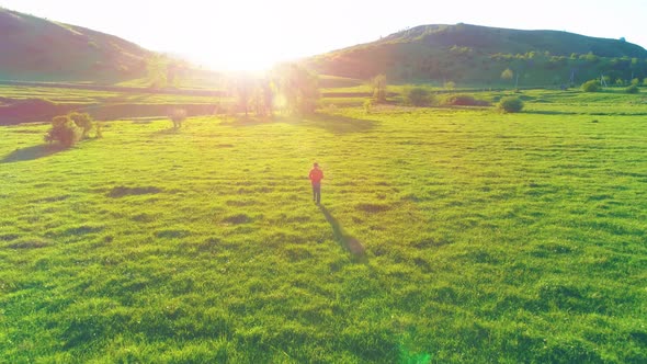 Flight Over Sport Man at Perfect Green Grass Meadow