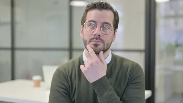 Portrait of Pensive Young Businessman Thinking