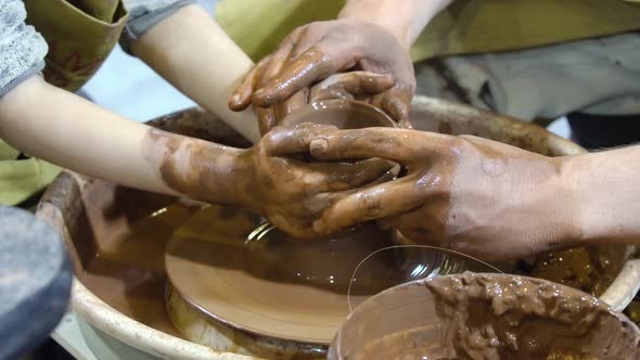 The Potters Wheel and Hands of the Potter.