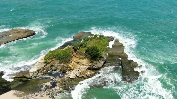 Eroded rock washed by ocean waves on Klayar beach, East Java, Indonesia, aerial