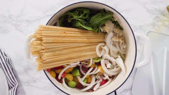 Flat lay. Step by step. Cooking on pot pasta recipe in an enameled cast iron dutch oven.