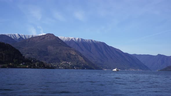Ship Sails on Lake Como Against the Backdrop of the Alps