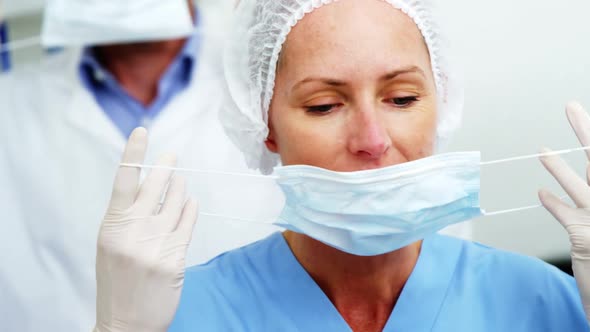 Dentist and dental assistant wearing surgical mask