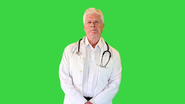 Strict Senior Doctor Looking To Camera on a Green Screen Chroma Key
