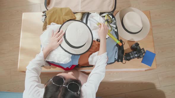 Woman Traveller Packing Clothes In A Suitcase For A New Journey. Luggage For Travel