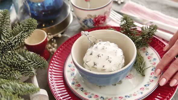 Christmas Table Decoration. Festive Table Setting. Female Hands Decorate the Table for Christmas