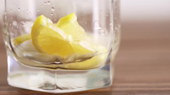 A Fresh Yellow Lemon Is Poured With Bubble Water