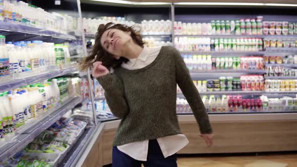 Young Woman Dancing Through Grocery Store Aisles