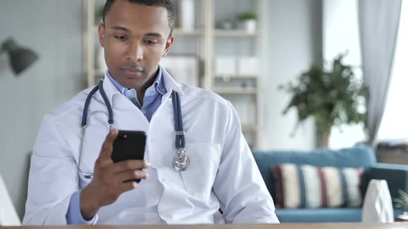 AfricanAmerican Doctor Using Smartphone