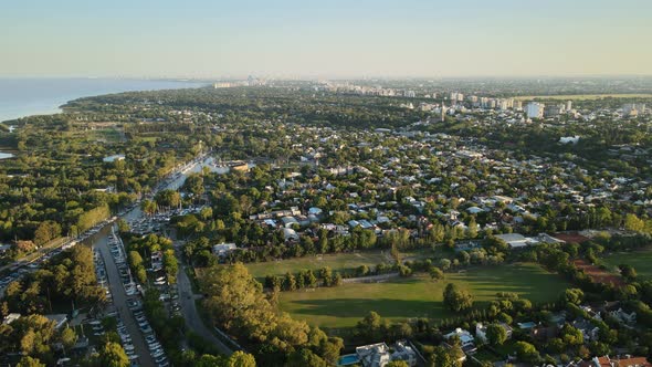 Aerial establishing shot of San Isidro coastal community and nautical clubs. Dolly in