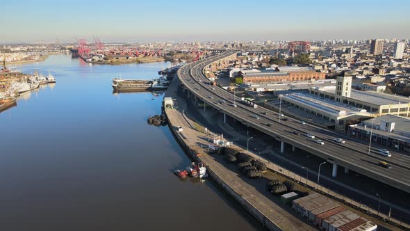 Aerial push-out of highway traffic by river and harbor in Buenos Aires