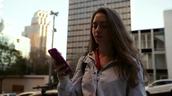 Woman using smartphone on city street