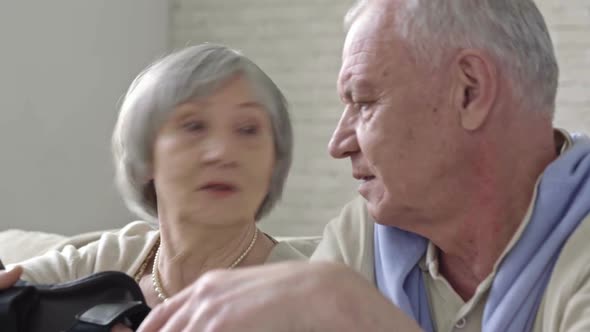 Senior Couple Discussing VR Headset