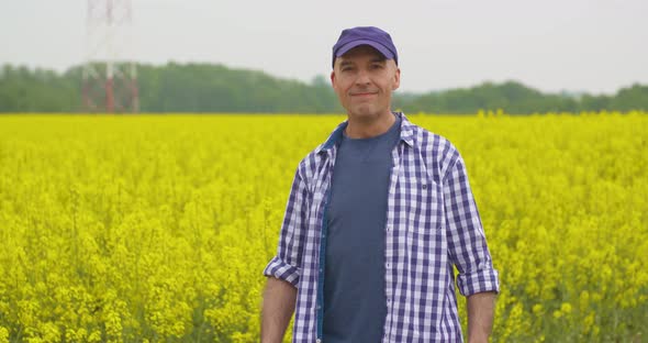 Farmer Examining Agriculture Field on Farm