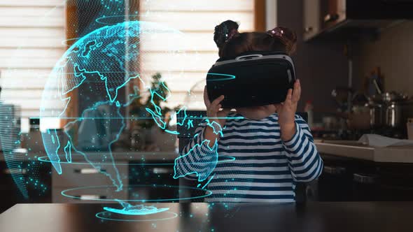 Child with Virtual Reality Headset Sitting Behind Table Indoors at Home
