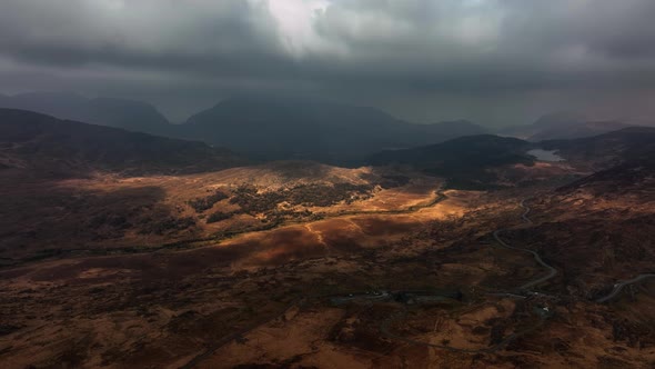 Killarney, Kerry, Ireland, March 2022. Drone tracks northwest over Derrynafunsha under a moody sky w