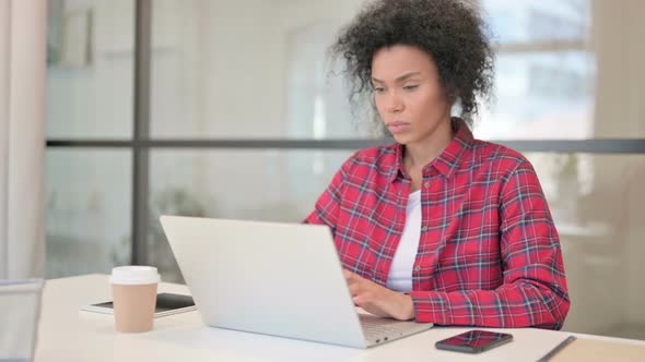 African Woman Having Back Pain While Using Laptop