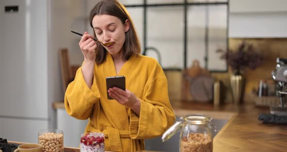 Woman Having a Breakfast on the Kitchen at Home