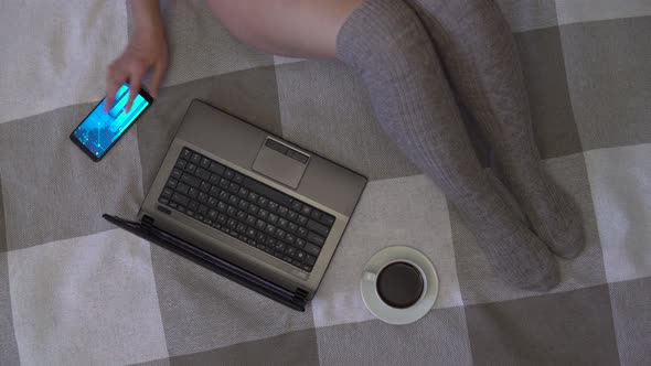 Overhead Shot, Business Girl Working Using Laptop and Mobile Phone While Sitting on the Bed at Home