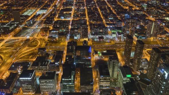 Time-lapse of car traffic and city building at night in Chicago city downtown.