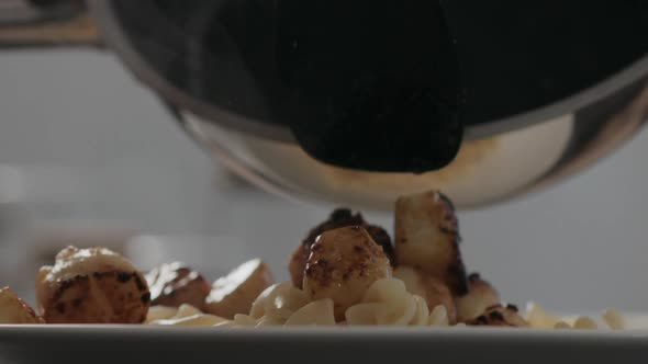 Slow Motion Closeup Put Fried Scallops on Fusilli Pasta