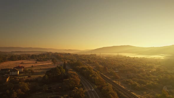 Aerial Scenery Drone Flight Over Hazy Mountain Walley at Sunrise