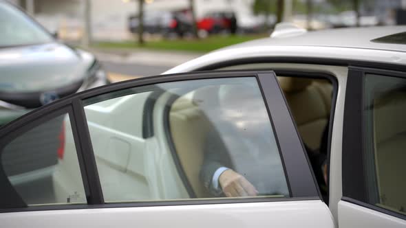 Businessman Exiting Rideshare Uber Lyft Car And Closing The Door