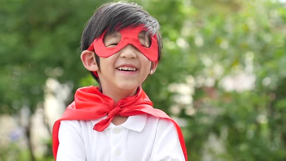 Asian Child In In Superhero Costume Playing In The Park Slow Motion