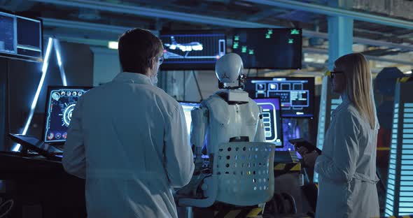 Laboratory Technicians Discuss the Indicators of the Experiment on Humanoid