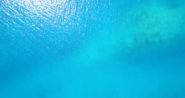 Tropical aerial travel shot of a summer white paradise sand beach and aqua blue ocean background 